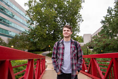 An IU South Bend student crossing the IU South Bend Pedestrian Bridge.